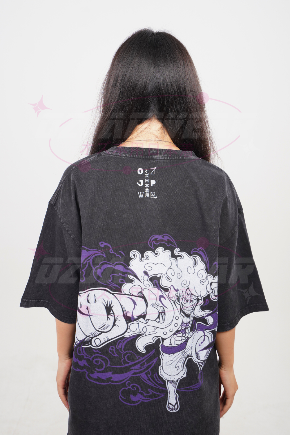 Back of black oversized tee showing large Luffy Gear 5 artwork in white and purple on washed black fabric.