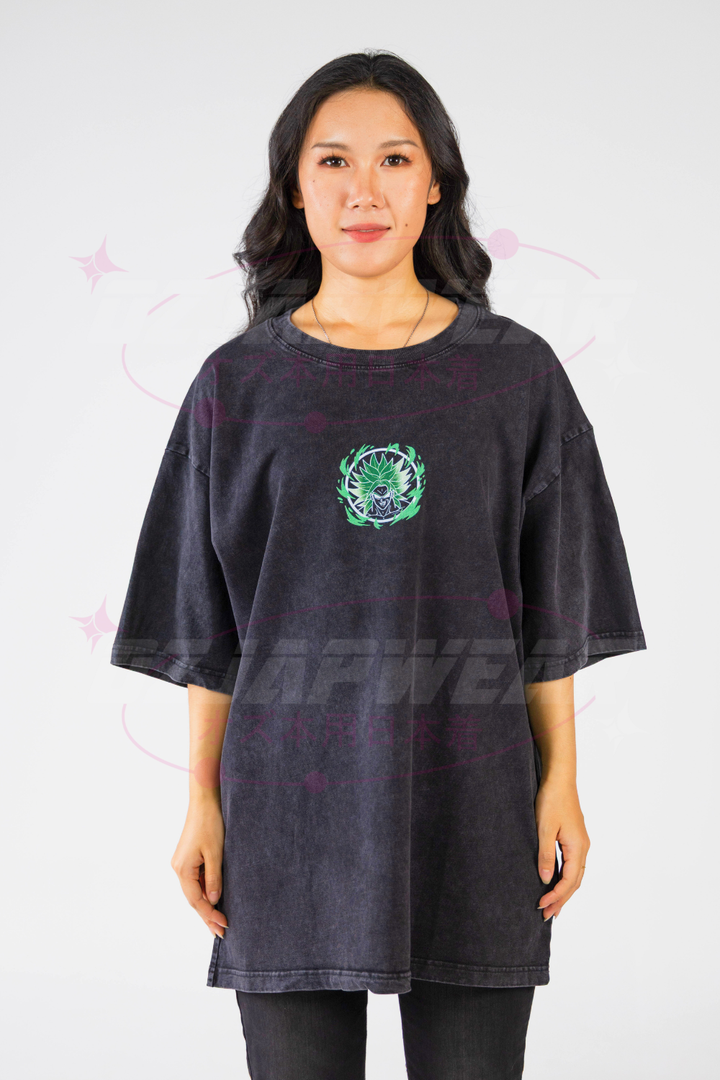 Model wearing black oversized tee with small neon green Broly emblem on the chest.
